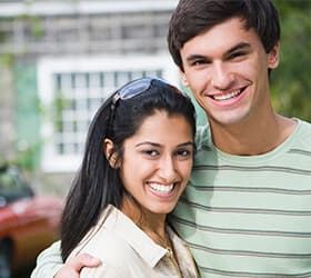couple with dark hair smiling